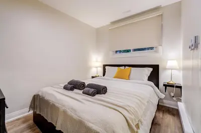 a bedroom with a large bed with two towels on it at Adrian's Suites 1Bedroom Junior Suite in Wasaga Beach