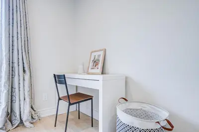 a desk with a chair and a picture on it at nest in orchard-main unit room in Toronto