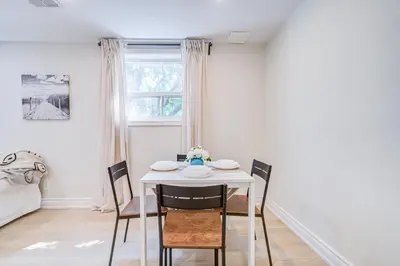 a dining room with a white table and chairs at nest in orchard-main unit room in Toronto