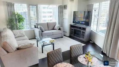 a living room with a couch and a tv at Pantages Skyline Suite in Toronto Centre - Free Parking in Toronto