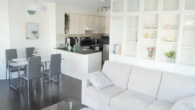 a living room with a white couch and a table at Pantages Skyline Suite in Toronto Centre - Free Parking in Toronto