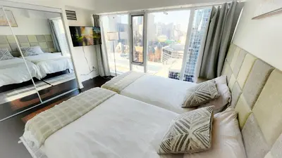 a hotel room with two beds and a large window at Pantages Skyline Suite in Toronto Centre - Free Parking in Toronto