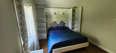 a small bedroom with a bed in a room at Sunny Corner Room with View in Toronto
