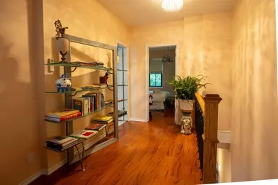 a room with a book shelf with books at Stylish 2BR Home with Front Yard and Free Parking in Toronto