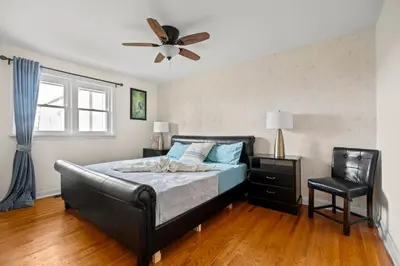 a bedroom with a bed and a ceiling fan at Beautiful home, a few minutes to the waterfall and attractions in Niagara Falls