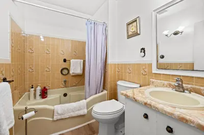 a bathroom with a sink and a toilet and a tub at Beautiful home, a few minutes to the waterfall and attractions in Niagara Falls