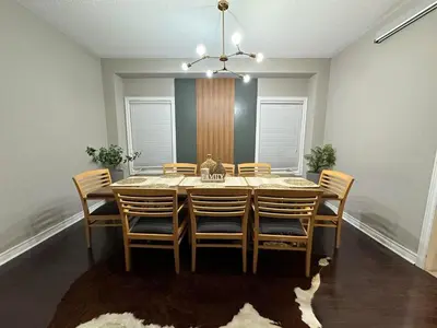 a dining room with a table and chairs at Luxurious Villa 3 Living Rooms, 1 sofa bed, 4 bedrooms, 4 Beds, 4 Toilets, 1 hour To Toronto in Oshawa