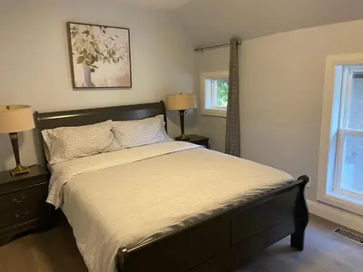 a bedroom with a bed and two lamps and a window at Rock place in Niagara Falls