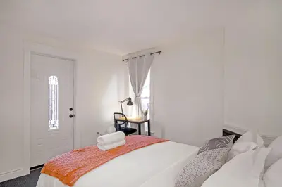 a white bedroom with a bed and a window at The Willow Suite Near DT & Hospital in Peterborough