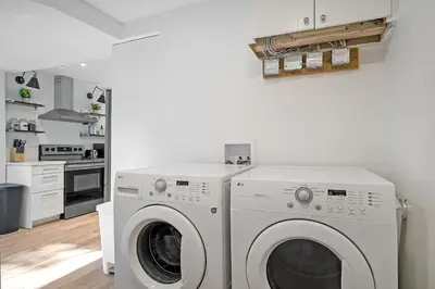 a white laundry room with a washer and dryer at The Willow Suite Near DT & Hospital in Peterborough