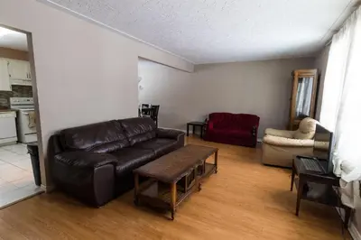 a living room with a leather couch and a table at HB GUEST HOME 2-entire house U3 beds in Waterloo