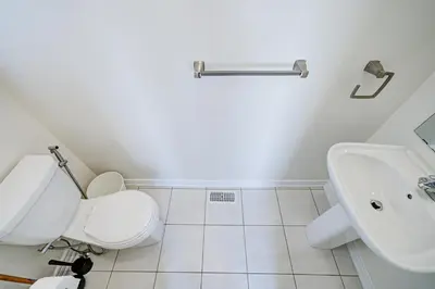 a white bathroom with a toilet and a sink at Richland Modern Luxury house in Richmond Hill