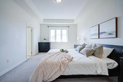 a large white bedroom with a large bed and a window at Richland Modern Luxury house in Richmond Hill