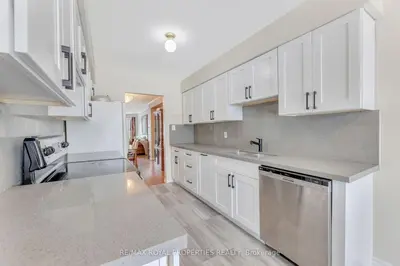 a kitchen with white cabinets and stainless steel appliances at Cozy Ajax Stay for Families in Ajax