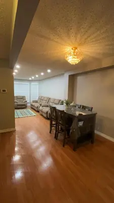 a living room with a table and a couch at Cozy Ajax Stay for Families in Ajax
