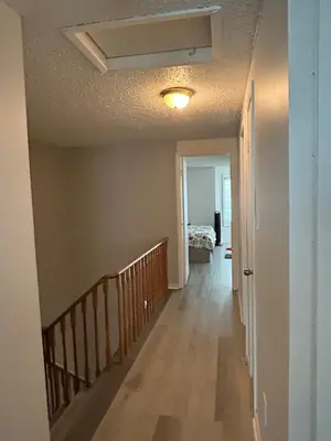 a hallway of a house with a staircase and a bedroom at Cozy Ajax Stay for Families in Ajax
