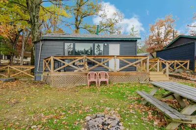 a house with two chairs in front of it at 2-Bedroom Cottage #10 - Pitch Pine in Gravenhurst