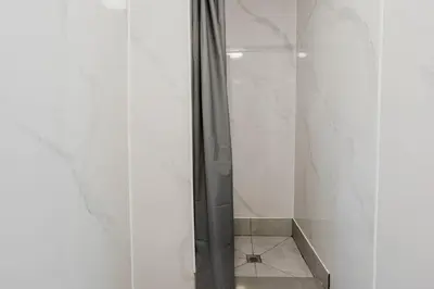 a shower in a bathroom with white walls at 3-Bedroom Cottage #7 - Austrian Pine in Gravenhurst