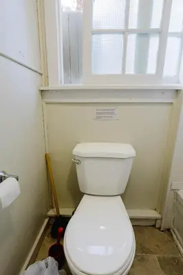 a white toilet in a bathroom with a window at 2-Bedroom Cottage #5 - Lodgepole Pine in Gravenhurst