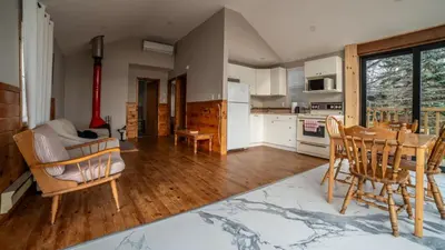 a kitchen and dining room with a table and chairs at Lake Muskoka 2-bedroom Cottage - Pier 100 #50 in Port Carling
