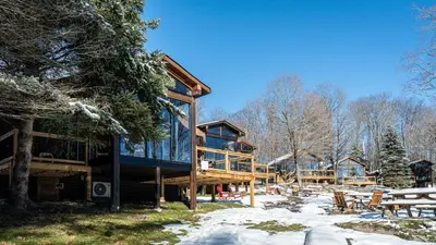 a cabin in the woods with snow on the ground at Lake Muskoka 2-bedroom Cottage - Pier 100 #50 in Port Carling