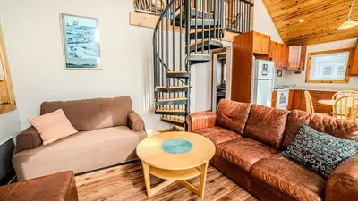 a living room with a couch and a table at Muskoka Lakefront 3-bdrm Chalet #90 in Port Carling