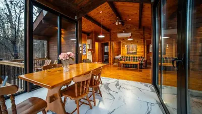 a dining room with a wooden table and chairs at Muskoka Lakeview Cottage - Pier 100 #40 in Port Carling