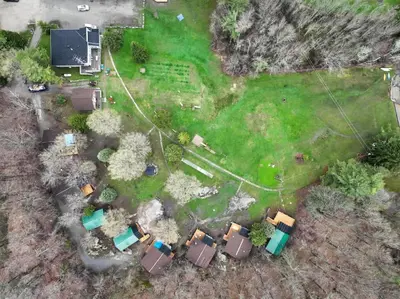 an aerial view of a yard with a house at Lake Muskoka 3-bedroom Cottage - Pier 100 #30 in Port Carling