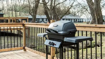a parking meter with a helmet on it next to a fence at 2-bedroom Lake Front Cottage in Harwood ON #4 in Harwood