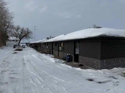 a snow covered building with a snow covered roof at 1-bedroom Townhouse in Harwood #2 in Harwood