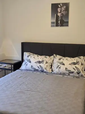 a bed in a bedroom with a bedskirtspectspectssenalsenalsenalsenalsenal at Modern 4 Bedroom Home -Oakville in Oakville