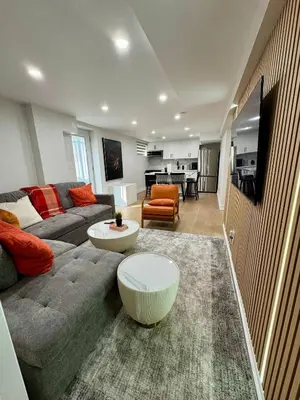 a living room with a couch and a table at 2 BR Private Basement Suite | Minutes from YYZ in Brampton
