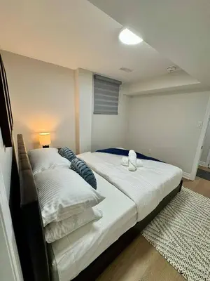 a bedroom with two beds in a room at 2 BR Private Basement Suite | Minutes from YYZ in Brampton