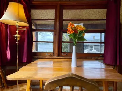 a table with a vase of flowers on top of it at 1-Bedroom Balsam Lake Cottage #9 in Kawartha Lakes