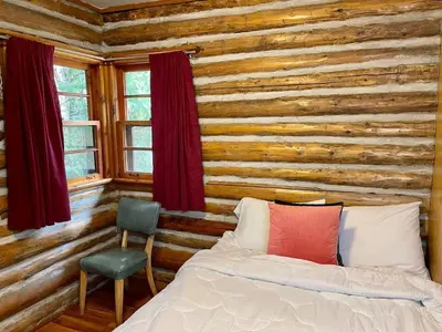 a bedroom with a bed and a wooden wall at Balsam Lake - 2-Bedroom House in Kawartha #15 in Kawartha Lakes