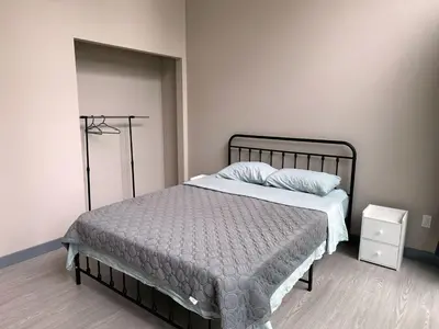 a bedroom with a bed with a metal frame at 3-bedroom Lakefront Villa #7 in Lakefield