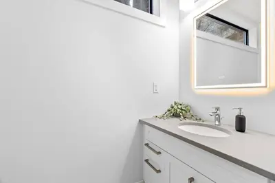 a bathroom with a sink and a mirror at RentX Cozy Downtown London Parking WiFi in London