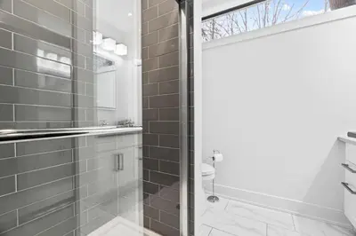 a bathroom with a shower with a glass door at RentX Cozy Downtown London Parking WiFi in London