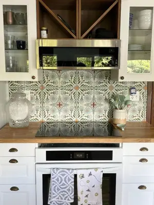 a kitchen with white cabinets and a stove at Muskoka Cabana - Sandy beach cottage in Muskoka in Utterson