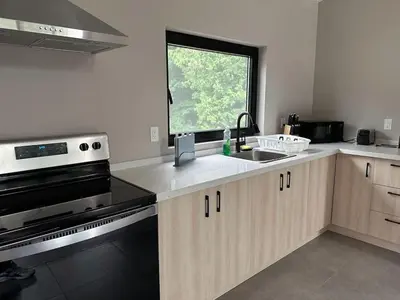 a kitchen with a stove and a sink and a window at 3-bedroom Villa in Lakefield #17 in Lakefield