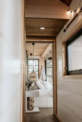 a bedroom in a tiny house with a bed at The Water’s Edge * * Unique Muskoka Treehouse * * in Utterson