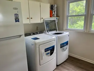 a kitchen with a washing machine and a refrigerator at Grand River Entire Cottage near Cambridge and Brantford in Cambridge