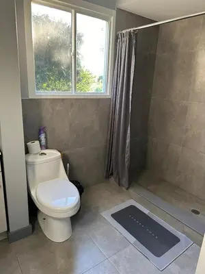 a bathroom with a toilet and a shower with a window at 5-bedroom Villa in East Gwillimbury in East Gwillimbury