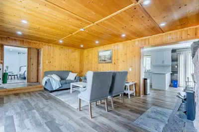 a living room with a couch and a table at Private cottage with 26 acre & outdoor games in Bracebridge