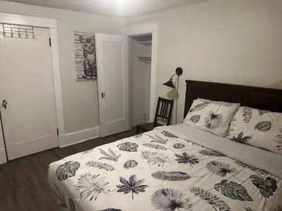 a bedroom with a bed with a floral bedspread at Maple Falls Oasis By Tig Management in Niagara Falls