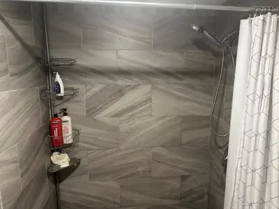 a bathroom with a shower with a shower curtain at Maple Falls Oasis By Tig Management in Niagara Falls