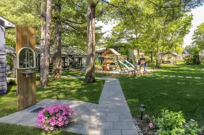 a backyard with a park with a playground at Spacious Second Floor Garden View Apartment in Wasaga Beach