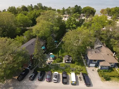 an overhead view of a yard with cars parked in a driveway at The Cozy Shore Cottage - Standard Attached in Wasaga Beach