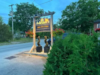 a sign for a restaurant on the side of the road at The Cozy Shore Cottage - Standard Attached in Wasaga Beach