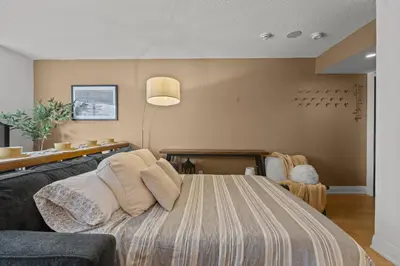 a bedroom with a large bed and a couch at RivetStays - The Pantages Suite in Toronto